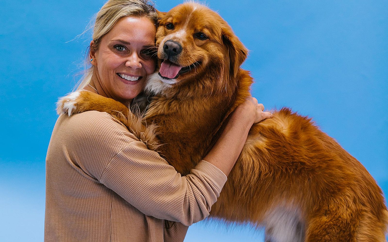 Person hugging her dog at home